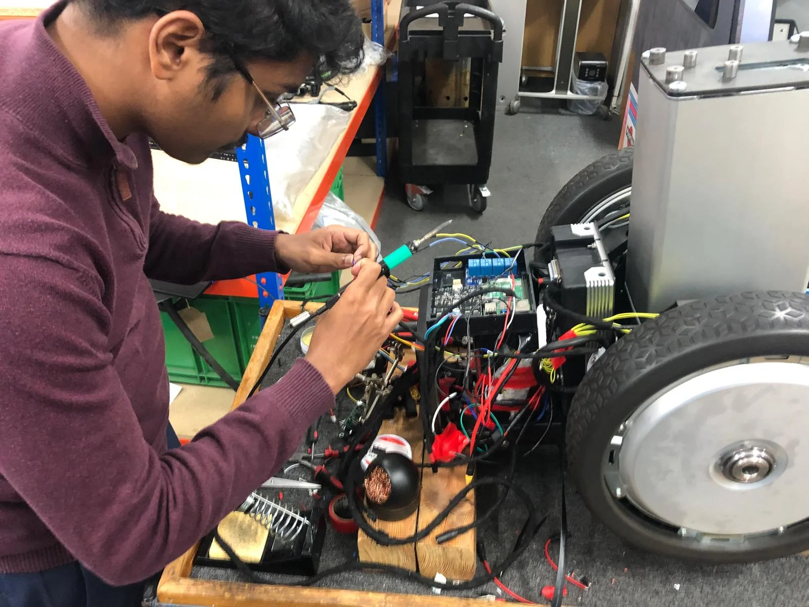 David Joseph, founder of DZbotics, working on robotics hardware